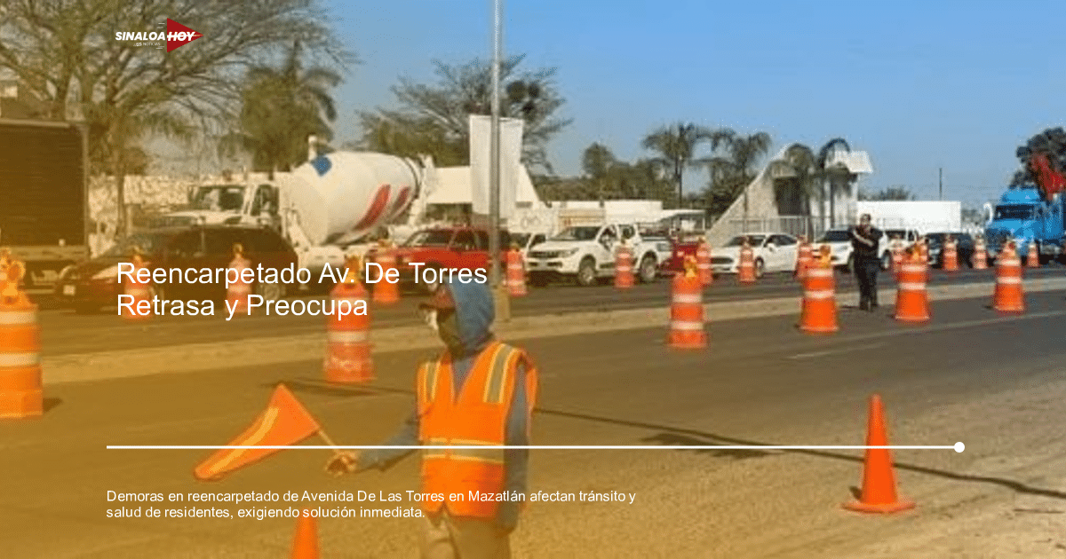 Tráfico detenido en la Avenida De Las Torres con coches, camión de cemento, conos naranjas y un trabajador con chaleco naranja.