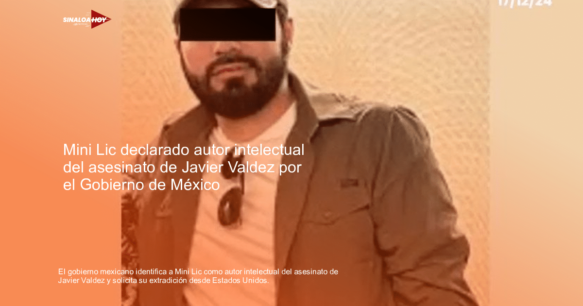 Hombre con barba, camiseta blanca, chaqueta gris y gafas de sol en entorno interior