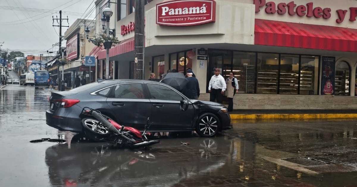 Accidente de tráfico en Mazatlán con automóvil y motocicleta en calle lluviosa