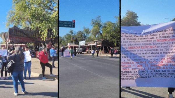 Manifestación en Los Mochis por cortes de electricidad en escuelas, con personas sosteniendo pancartas en la calle.