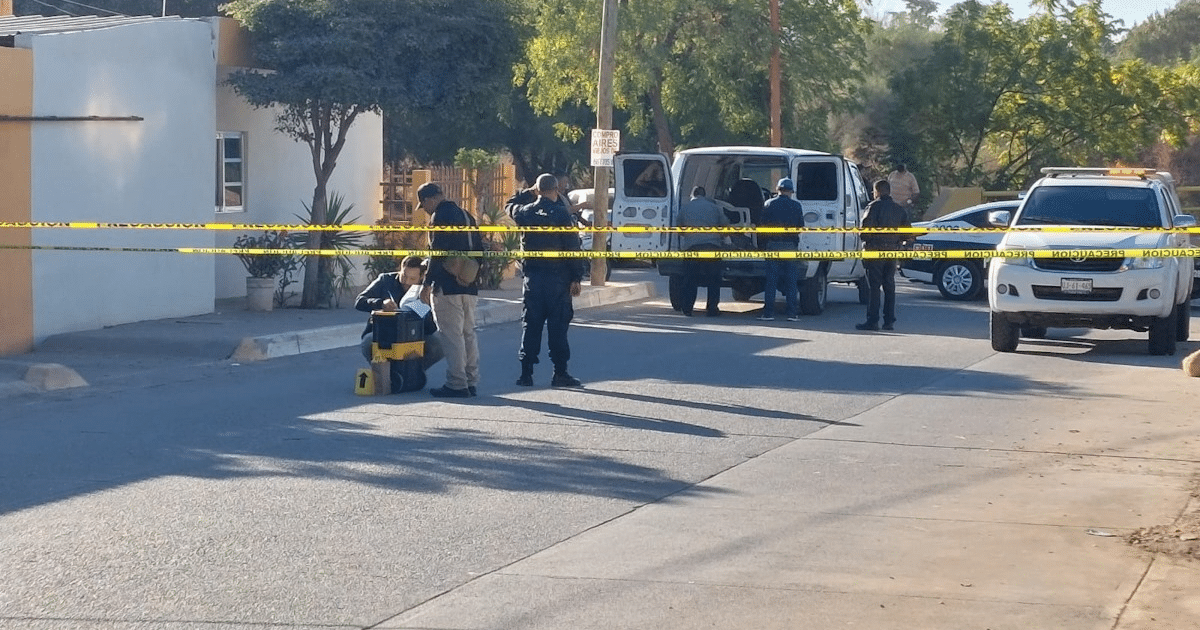 Oficiales investigan escena de crimen en Guamúchil con cinta de restricción y vehículos policiales.