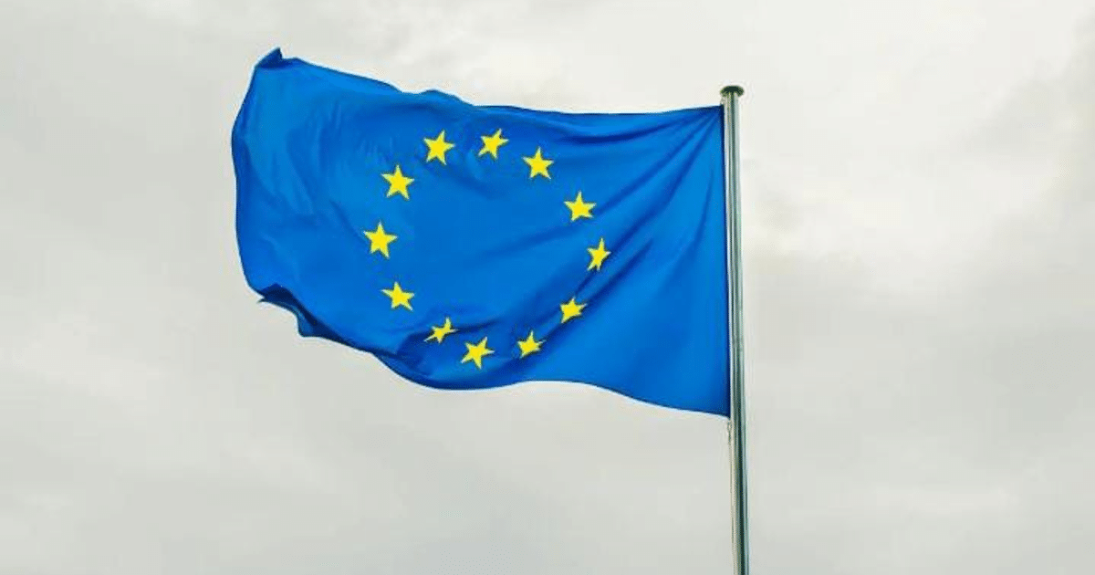 Bandera azul de la Unión Europea con doce estrellas amarillas en círculo.