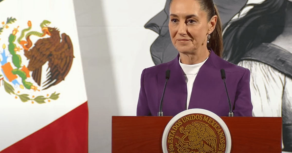 Claudia Sheinbaum en conferencia de prensa sobre aranceles, con bandera de México de fondo.