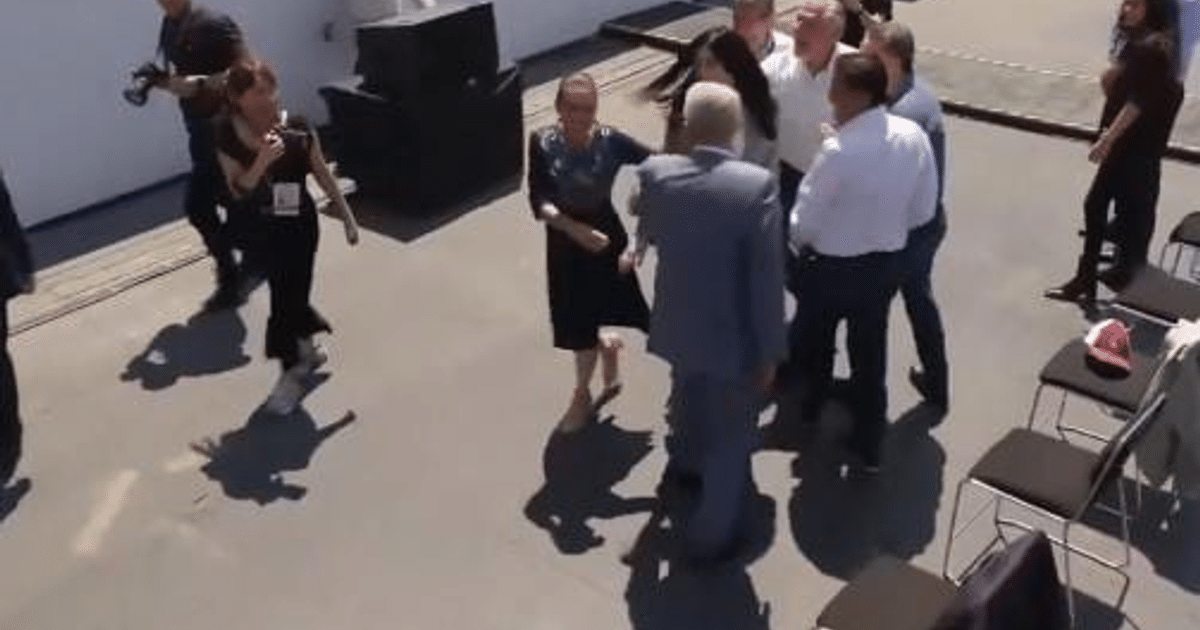 Grupo de personas en evento al aire libre del Consejo Nacional de Morena, con sillas vacías y actividad fotográfica.