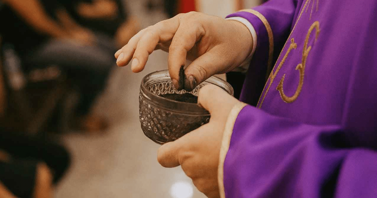 Mano sosteniendo recipiente con cenizas en ceremonia religiosa de Miércoles de Ceniza