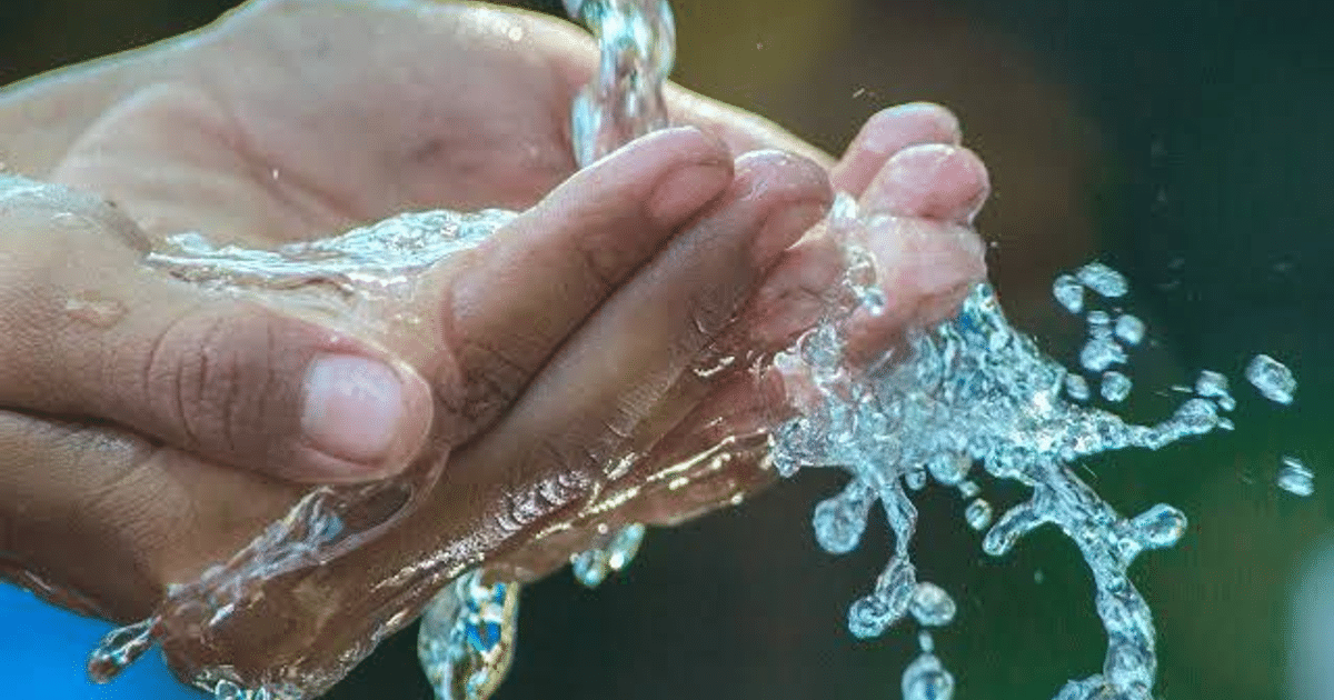 Manos sosteniendo agua salpicante, simbolizando la escasez de agua en Sinaloa.