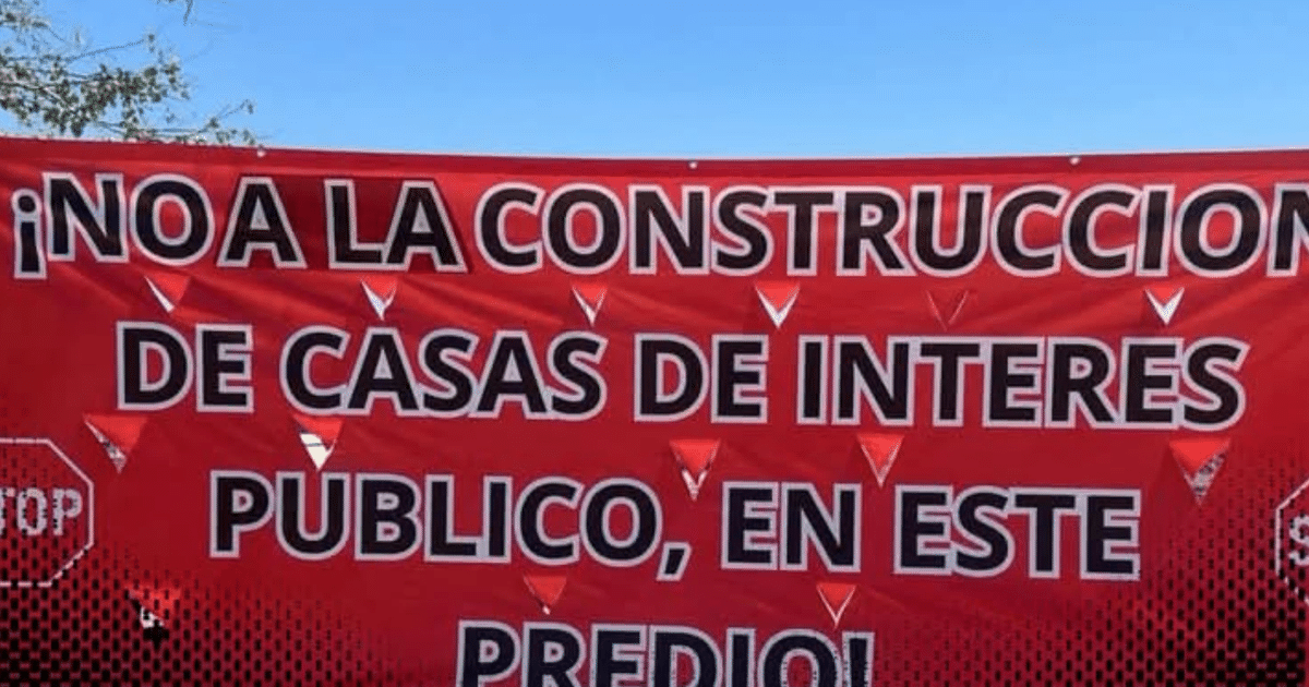 Pancarta roja con mensaje de oposición a viviendas de interés social en Stanza