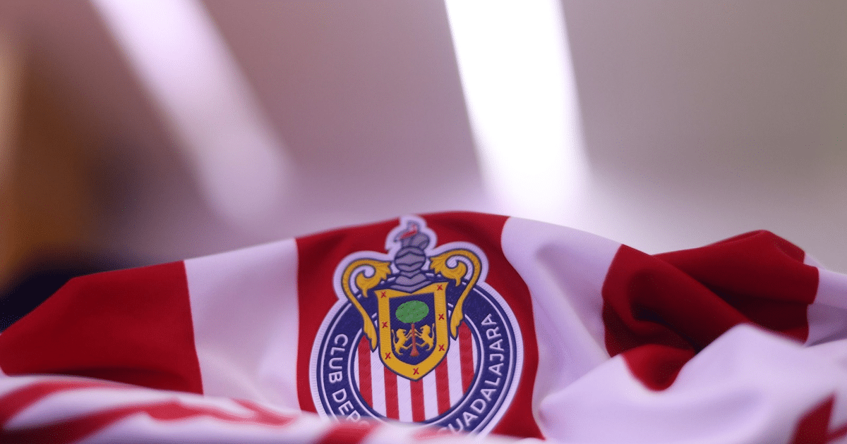Camiseta de Chivas con rayas rojas y blancas y el logo del club