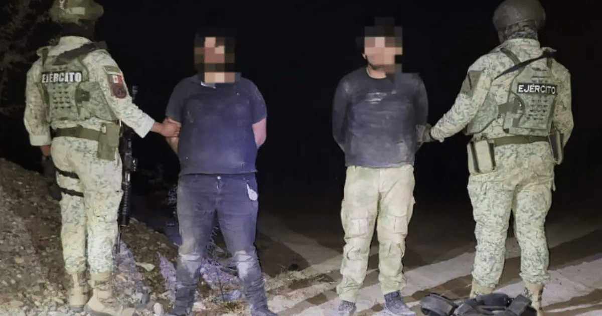Dos hombres detenidos por soldados en uniforme de camuflaje durante un operativo nocturno en San Ignacio.