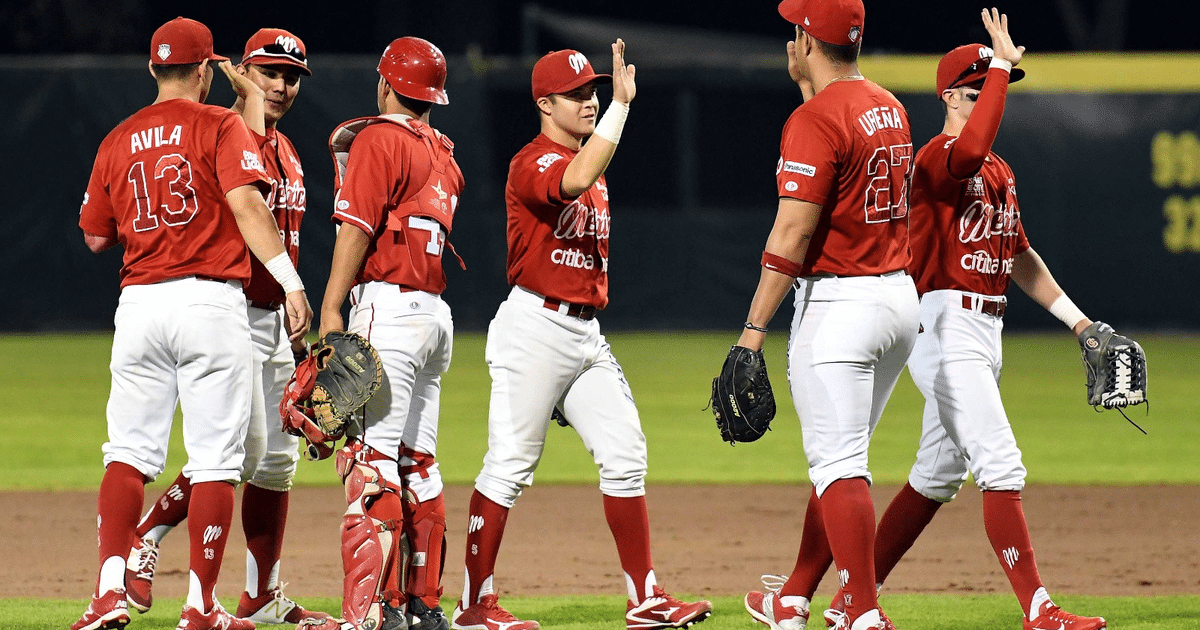 Jugadores de béisbol de los Pingos celebrando en el campo tras victoria