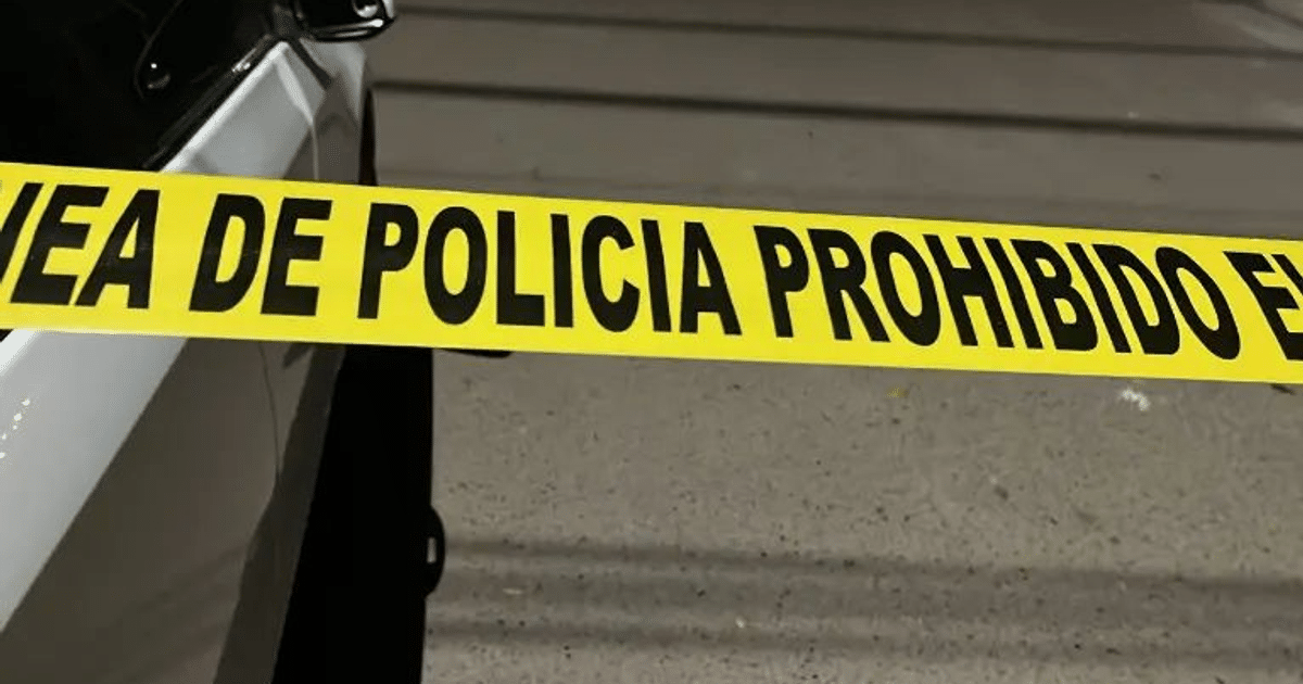 Cinta de advertencia amarilla en escena de tiroteo en Culiacán con vehículo de emergencia al fondo.