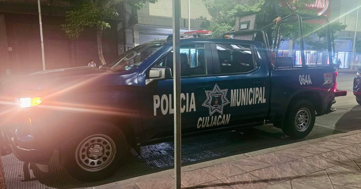 Camioneta de la policía municipal de Culiacán con luces encendidas durante la noche.