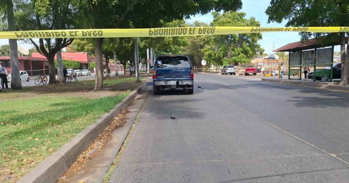 Calle acordonada en Culiacán tras accidente vial, con vehículo azul y tráfico visible.
