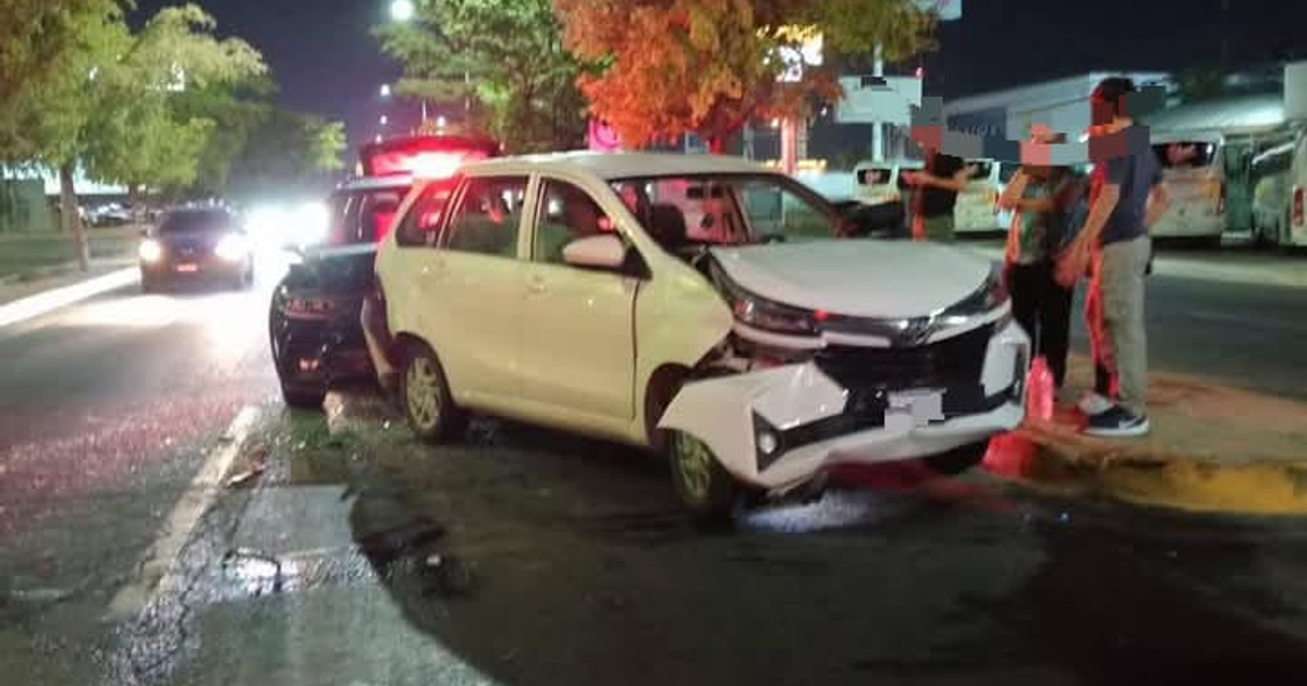 Accidente automovilístico nocturno en la carretera México 15 con un coche blanco dañado y personas alrededor.