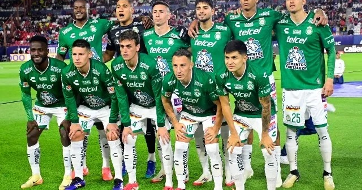 Equipo de fútbol León posando en el estadio con camisetas verdes y pantalones blancos.