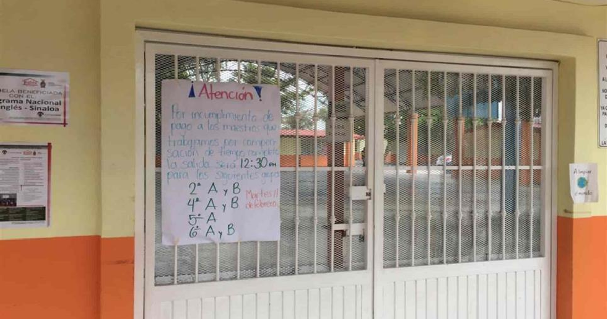 Puerta con aviso de horario especial en escuela Ford 31, Mazatlán.