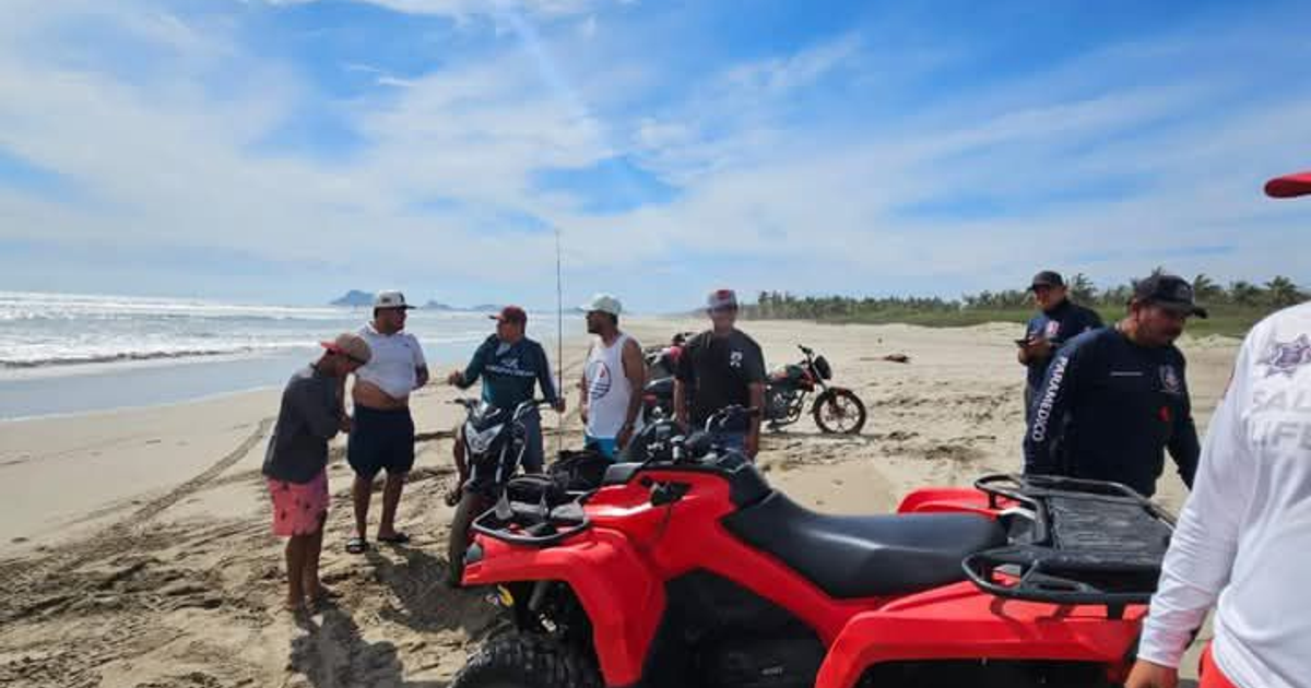 Personas en la playa con cuatrimotos y motocicletas durante un operativo de rescate en Isla de la Piedra