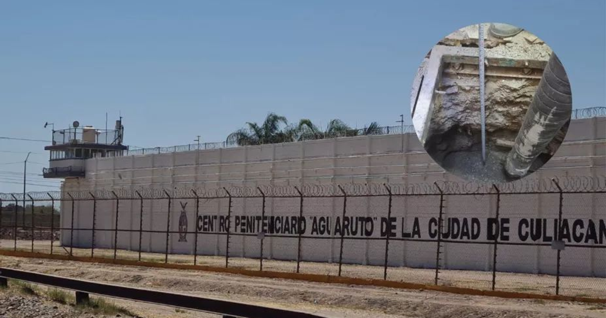 Exterior del Centro Penitenciario Aguaruto con torre de vigilancia y cercado de alambre de púas, mostrando un detalle de un conducto en el suelo.