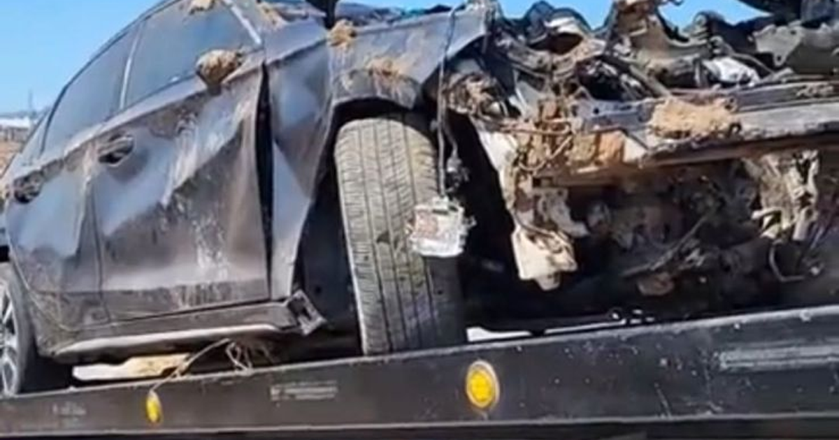 Honda Civic gris dañado en accidente, transportado en plataforma