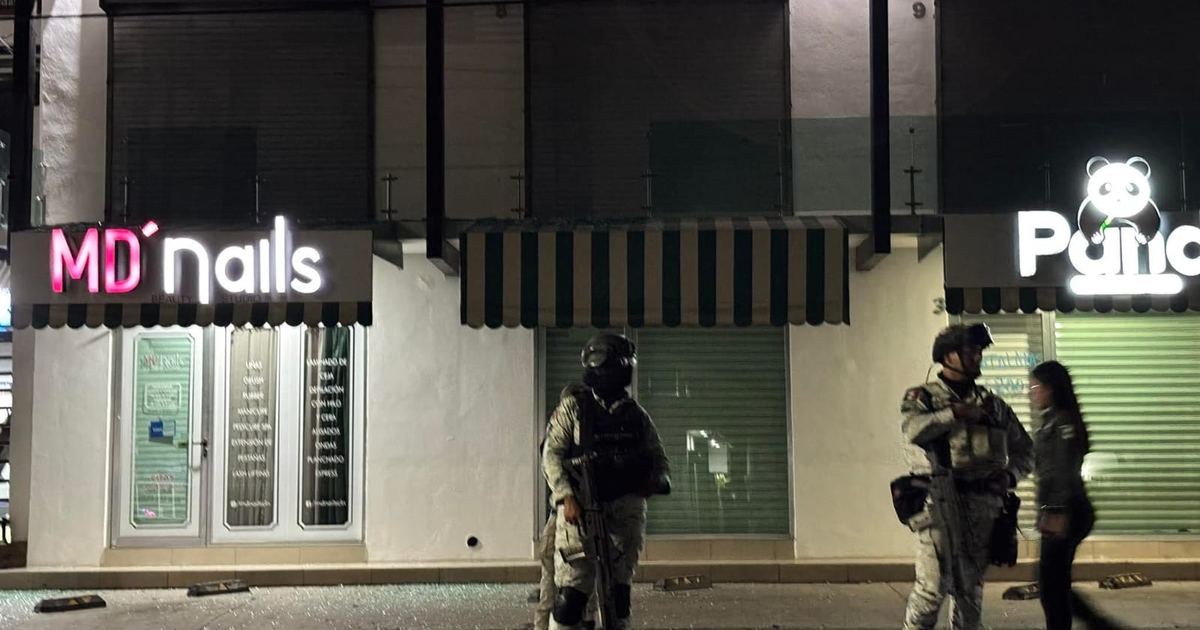 Escenario nocturno en Culiacán con negocios 'MD'nails' y 'Panda', personas con ropa táctica y una mujer caminando, reflejando la situación de seguridad tras tiroteos.