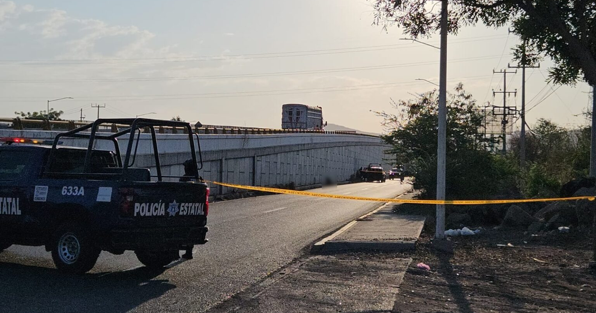 Vehículo policial y cinta de precaución en escena del crimen en puente Obregón Costerita, Culiacán.