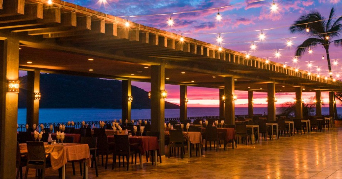 Restaurante al aire libre en Mazatlán con atardecer y palmeras