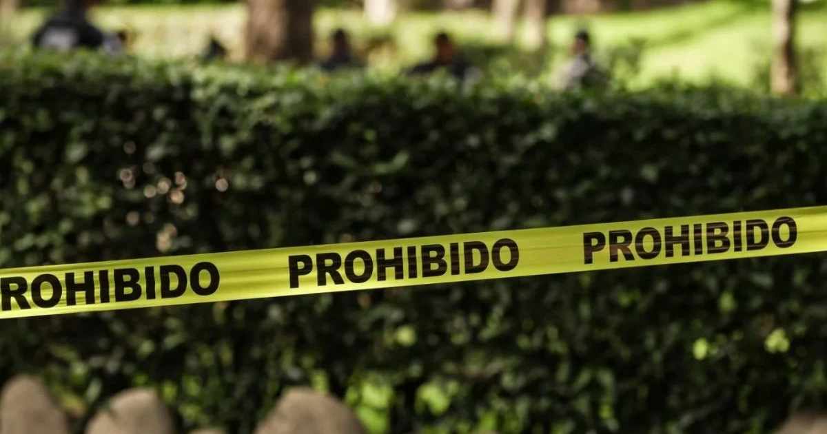 Cinta amarilla de 'PROHIBIDO' en escena de crimen en San Cristóbal de la Barranca, Jalisco.