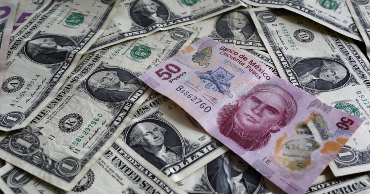 Billetes de dólar estadounidense y 50 pesos mexicanos sobre una superficie plana.