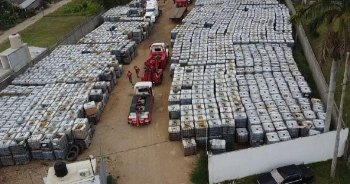 Terreno industrial con contenedores y vehículos, vinculado al tráfico ilícito de combustibles.