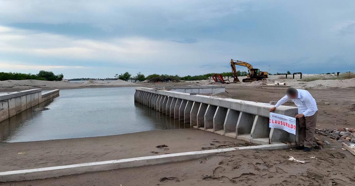Sitio de construcción clausurado en Navolato, Sinaloa, con maquinaria pesada y cartel de 'CERRADO'.