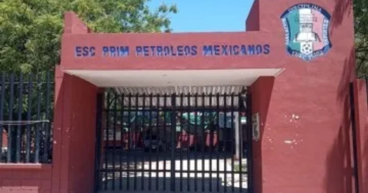 Entrada de la Escuela Primaria 'Petróleo Mexicano' con diseño sencillo y puerta de rejas, tras un robo violento.