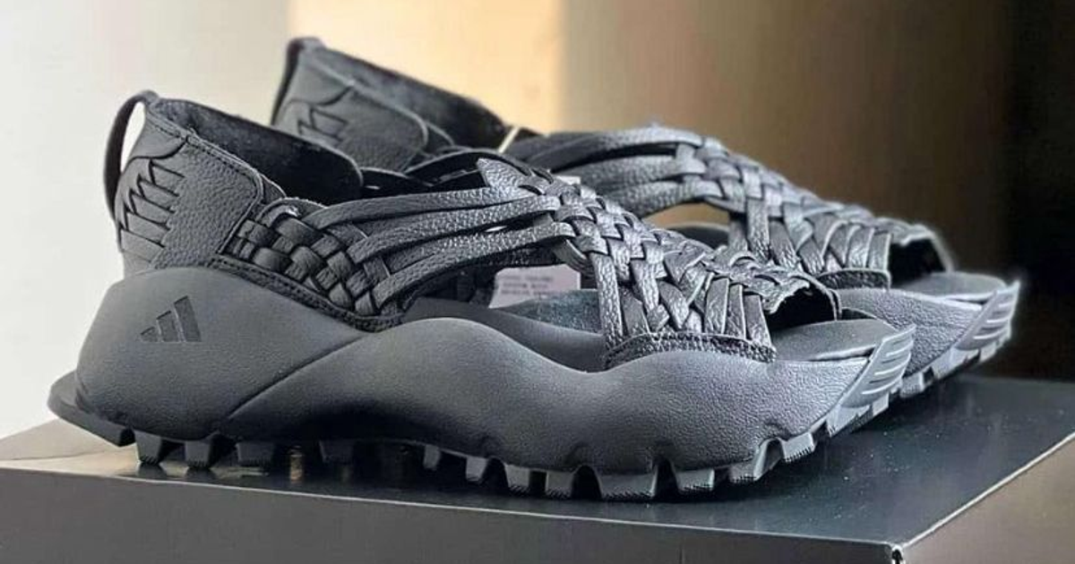 Sandalias negras con diseño trenzado y suela robusta sobre una caja