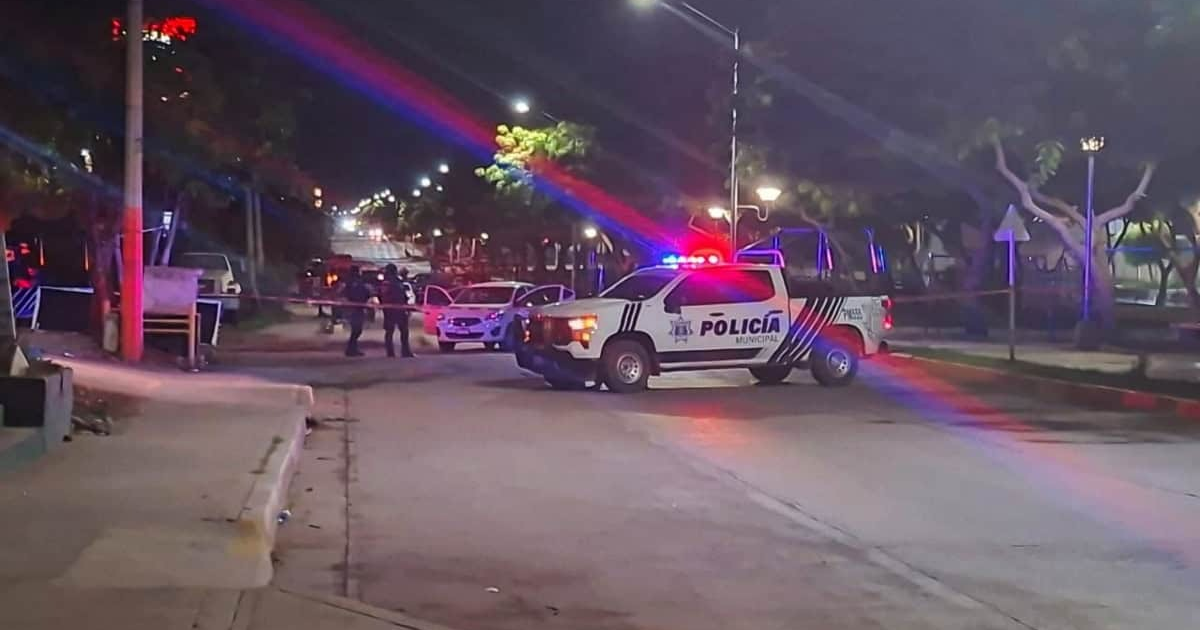 Operativo nocturno de policía en Mazatlán con luces intermitentes y oficiales en la calle.