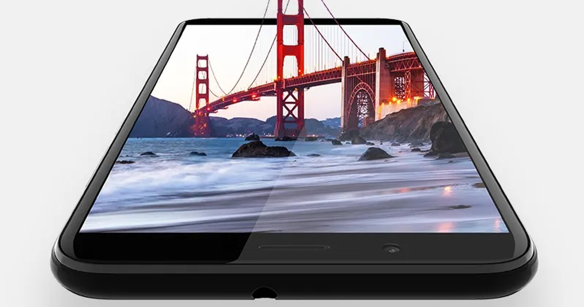 Teléfono móvil con imagen del Golden Gate Bridge en pantalla, sobre fondo blanco.