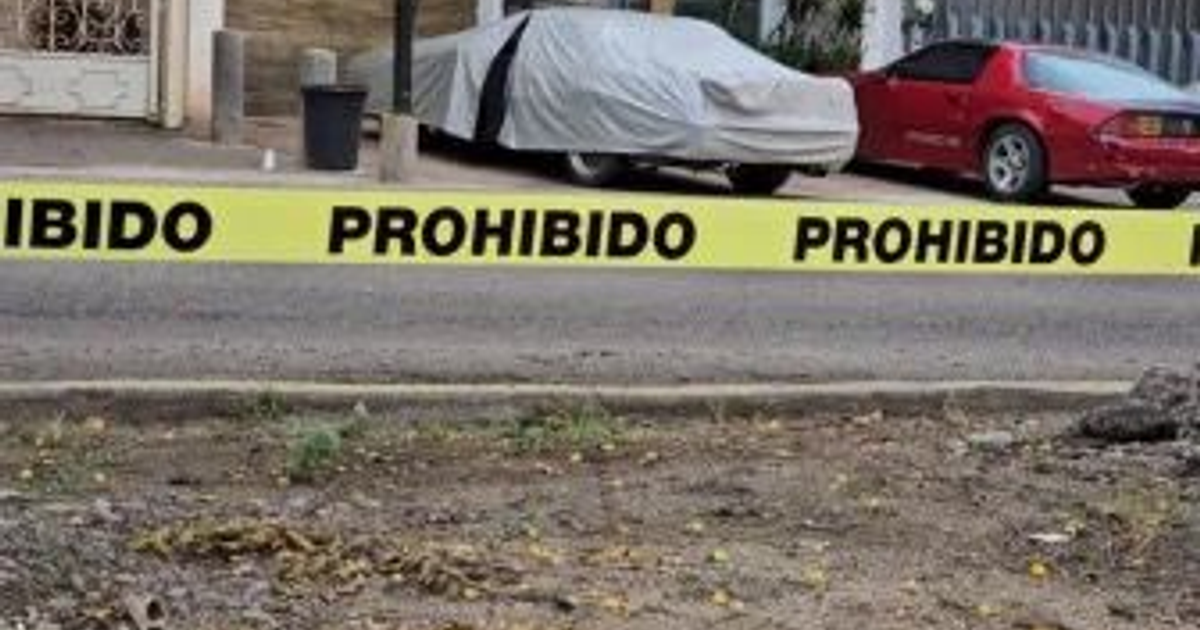 Cinta amarilla de 'PROHIBIDO' en escena de crimen con automóviles en Culiacán