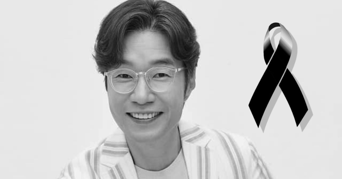 Persona sonriente con gafas y atuendo de rayas, con lazo negro en esquina, en memoria de Song Young-kyu.