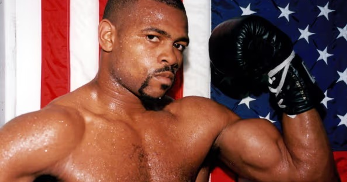 Boxeador musculoso con guante de boxeo negro y bandera estadounidense de fondo