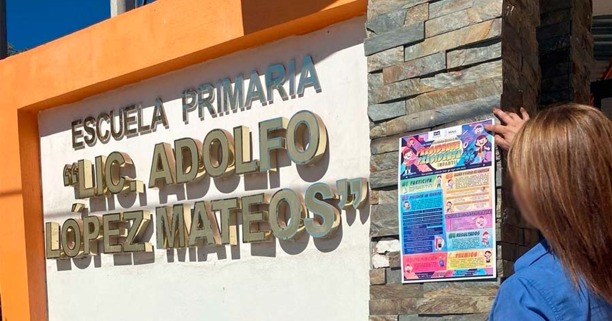 Cartel en la entrada de la escuela primaria Lic. Adolfo López Mateos con persona colocando documento.