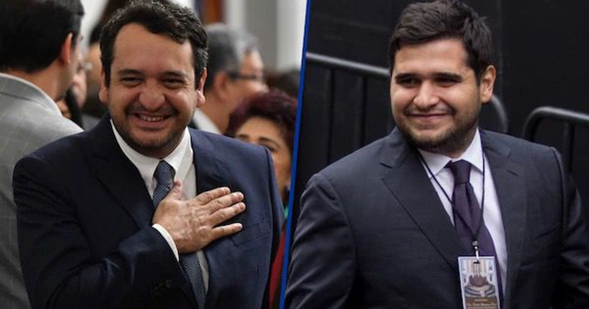 Dos hombres en trajes formales, uno con mano en el pecho y otro con gafete, relacionados con suspensión judicial.