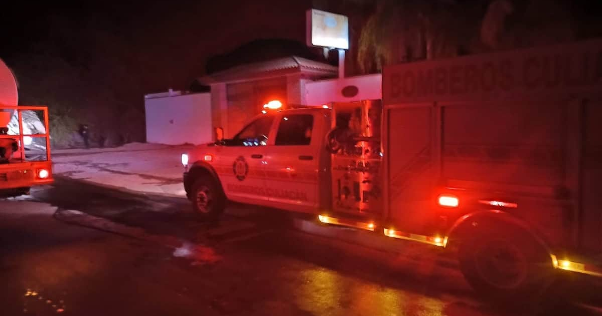 Camión de bomberos con luces encendidas en Navolato durante la noche, tras un incendio provocado.