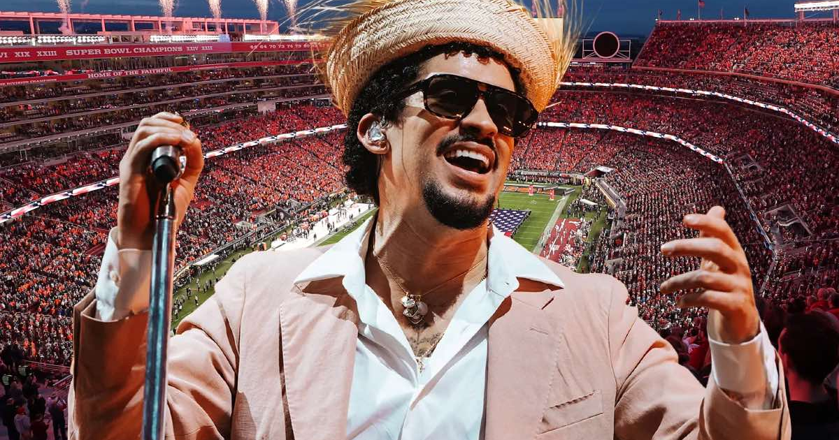 Bad Bunny actuando en el Super Bowl LX con gafas de sol y sombrero, rodeado de una multitud y fuegos artificiales.