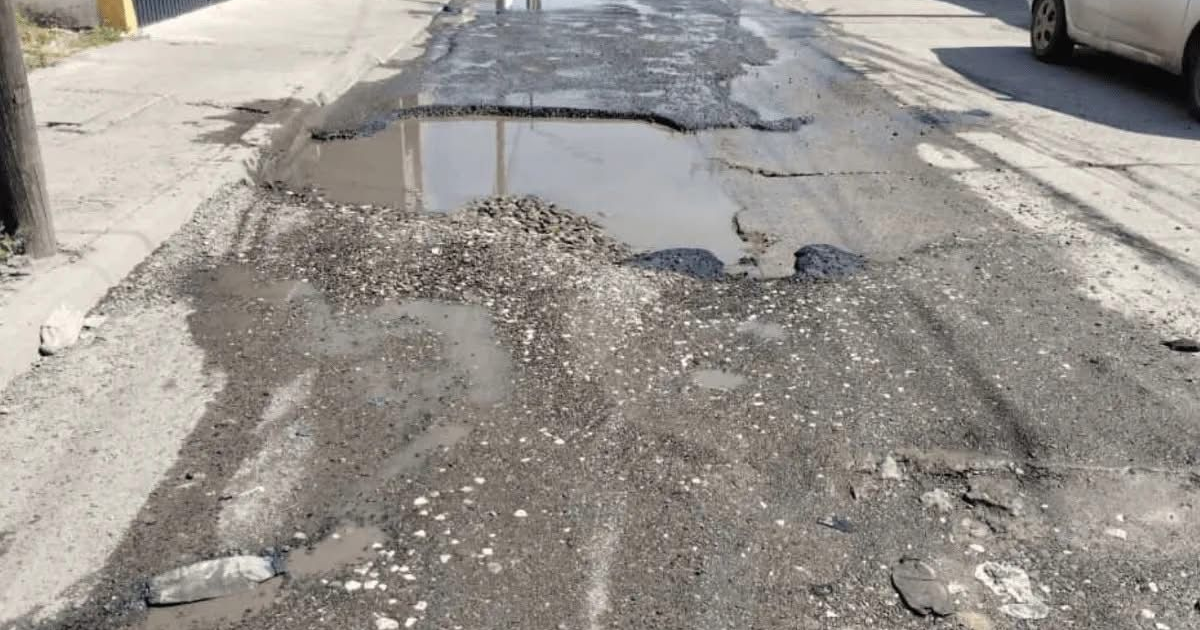 Camino con baches y agua acumulada en calle Felipe Ángeles, Infonavit Playas.