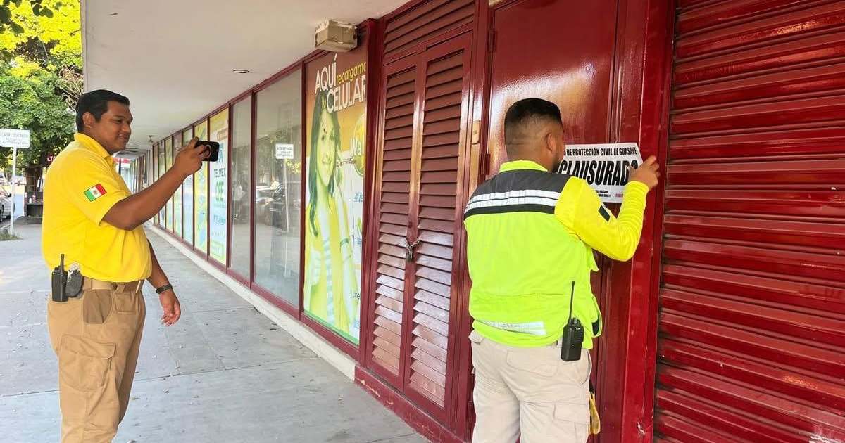 Hombres clausurando tienda Waldo's en Guasave por fallas de seguridad