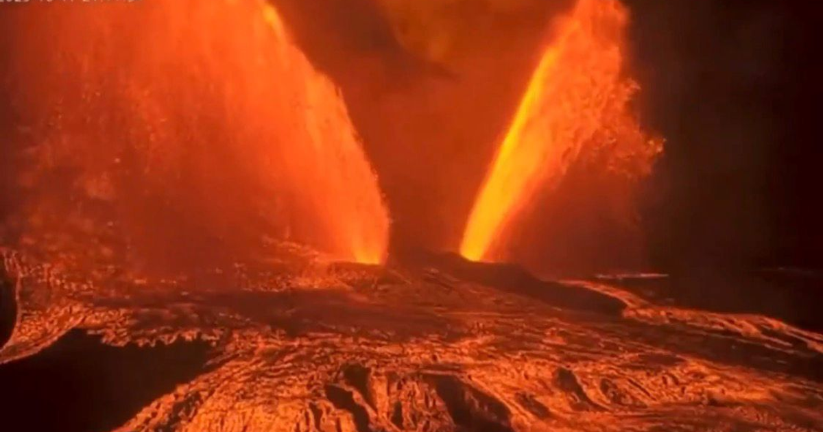 Erupción del volcán Kīlauea con lava y gases en el aire, colores naranjas y rojos predominantes.