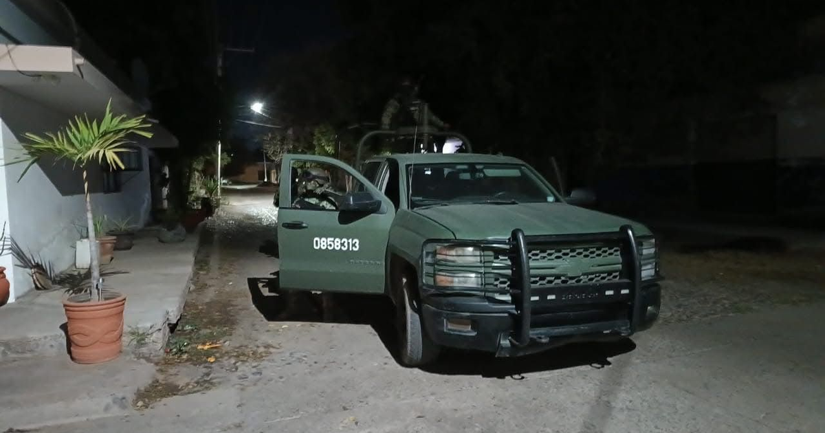 Camioneta verde de seguridad estacionada en una calle de Navolato, Sinaloa, durante la noche.