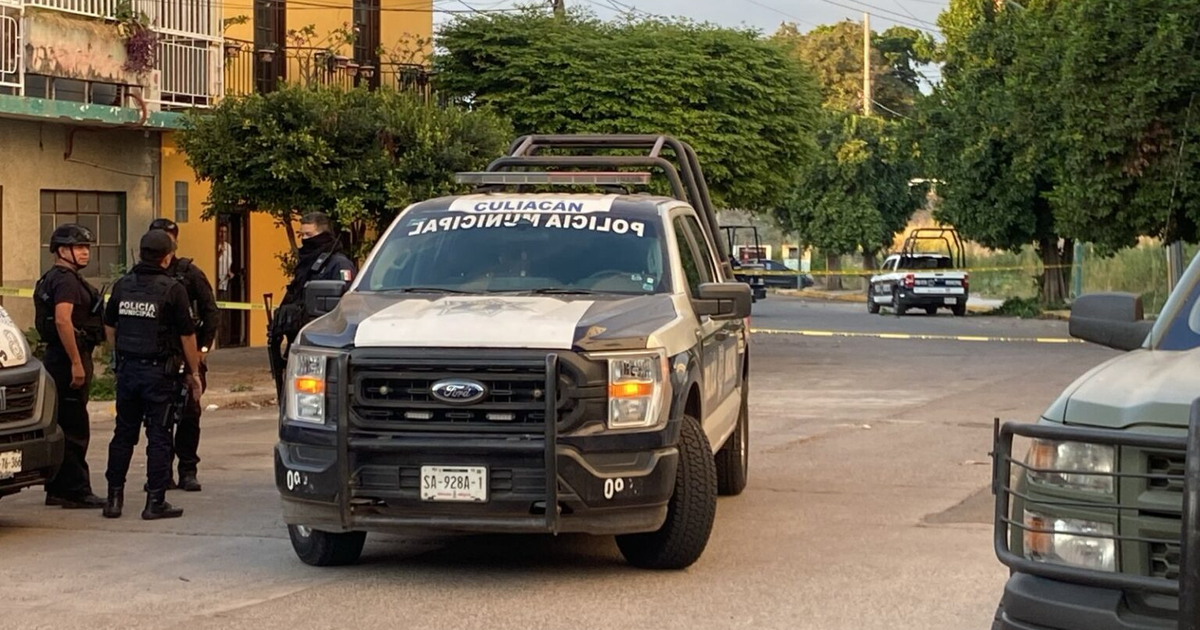Policías municipales en Culiacán investigan escena del crimen con cinta amarilla y camioneta de policía visible.