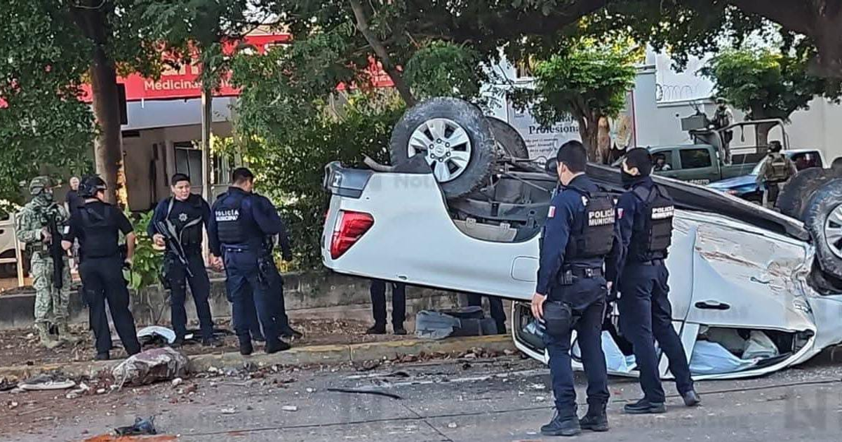Foto del coche volcado en Culiacán, con oficiales de policía presentes en la escena