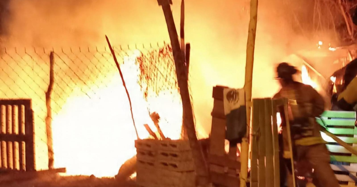 Imagen de un incendio en Mazatlán mostrando llamas intensas y un bombero en acción