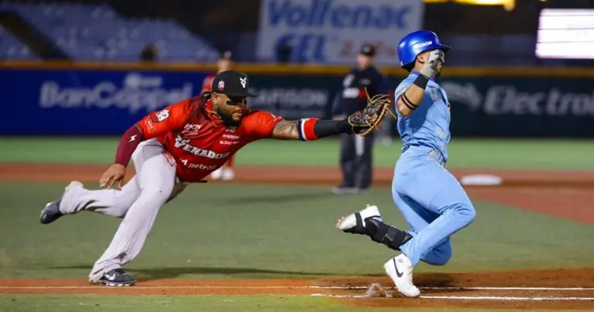 Jugador de los Venados de Mazatlán corre hacia la base mientras un Charros de Jalisco intenta tocarlo con el guante en el Estadio Panamericano.