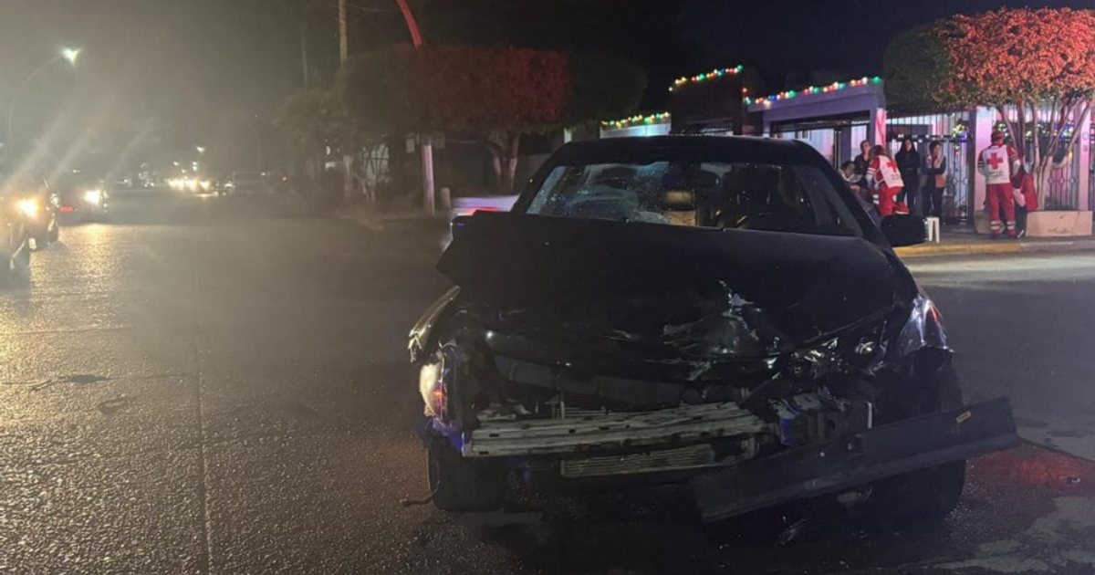 Automóvil dañado tras accidente nocturno en Los Mochis, con luces de emergencia y asistencia de la Cruz Roja.